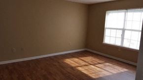 Statesboro apartment for rent - A room with a window and wooden flooring.