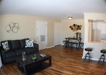 Lodi apartment for rent - a living room with a couch and a coffee table in front of a dining room