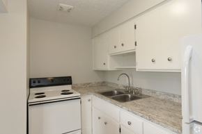Lodi apartment for rent - a kitchen with white appliances and granite counter tops and white cabinets