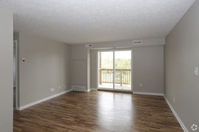 Lodi apartment for rent - an empty living room with wooden floors and a sliding glass door