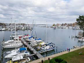 Annapolis apartment for rent - A marina with boats docked and people walking on the dock.