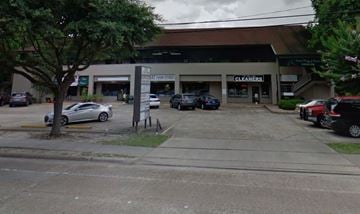 Houston apartment for rent - a parking lot with cars parked in front of a building