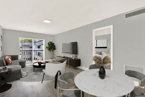 N. Miami apartment for rent - A modern living room with a white marble table and grey chairs.