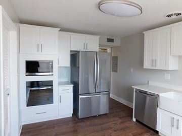Shaker Heights apartment for rent - a kitchen with white cabinets and stainless steel appliances