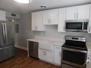 Shaker Heights apartment for rent - a kitchen with white cabinets and stainless steel appliances