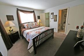 Spartanburg apartment for rent - a bedroom with a bed and a window and a door to a bathroom