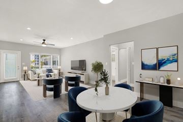 Bay Harbor Islands apartment for rent - A modern living room with a white table and blue chairs.