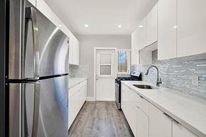 Bay Harbor Islands apartment for rent - A modern kitchen with a stainless steel refrigerator and white cabinets.