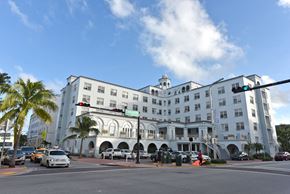 Miami Beach apartment for rent - a large white building on the corner of a city street