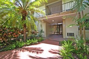 Miami apartment for rent - a view of the entrance to a house with a palm tree