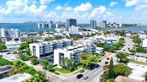 Miami Beach apartment for rent - A view of a city with buildings, trees, and a body of water.