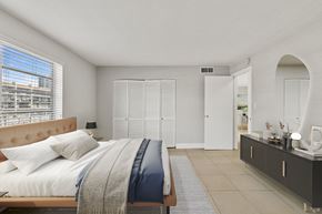 N.Miami Beach apartment for rent - A bedroom with a large bed and a window with blinds.