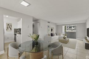 N.Miami Beach apartment for rent - A modern dining room with a glass table and chairs.
