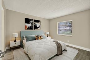 Fort Pierce apartment for rent - A bedroom with a large bed and a painting on the wall.