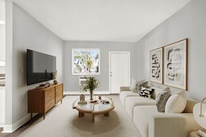 N. Miami Beach apartment for rent - A living room with a white couch, a wooden coffee table, and a flat-screen TV.