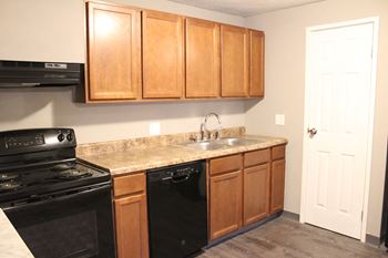 Wooden cabinets and black appliances