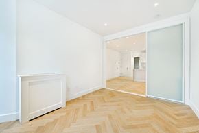 Brooklyn apartment for rent - a living room with a hardwood floor and a sliding glass door