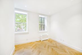 Brooklyn apartment for rent - an empty room with wood floors and two windows