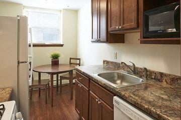 Minneapolis multi-family for rent - a kitchen with a sink and a table