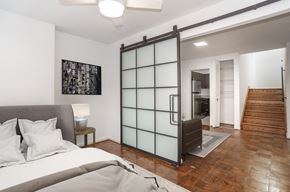Washington apartment for rent - a bedroom with a bed and a sliding glass door