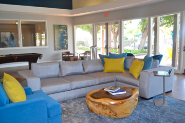 Redlands apartment for rent - A living room with a blue couch and yellow pillows.