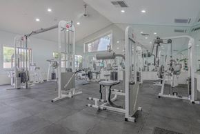 Redlands apartment for rent - A gym with a variety of equipment including treadmills, weights, and exercise machines.
