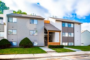 Shawnee apartment for rent - the front of an apartment building with a sidewalk and grass
