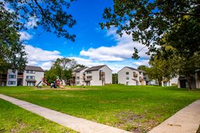 Shawnee apartment for rent - a group of houses in a park with a playground