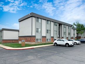 Mission apartment for rent - a large building with cars parked in front of it