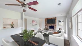 Mission apartment for rent - a living room with white furniture and a brick fireplace