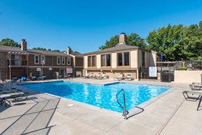 Olathe apartment for rent - our apartments offer a swimming pool with our building in the background