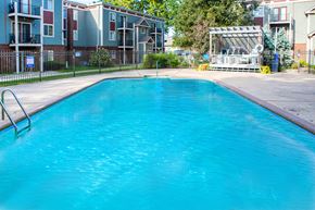 Lee's Summit apartment for rent - a large swimming pool in front of an apartment building