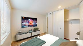 Lee's Summit apartment for rent - a bedroom with a large bed and a white closet