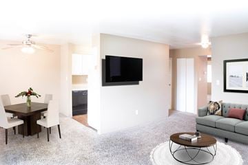 Gladstone apartment for rent - a living room and dining room with a couch and a table