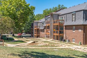 Lee's Summit apartment for rent - our apartments offer a spacious courtyard with green grass and trees