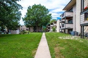 Lee's Summit apartment for rent - the grassy area between two apartment buildings on a sunny day