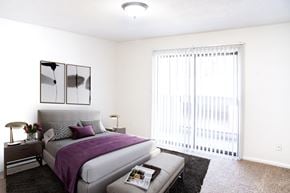 Lee's Summit apartment for rent - a bedroom with a bed and a large window