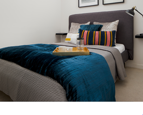 Philadelphia apartment for rent - a bedroom with a bed with a blue blanket and pillows