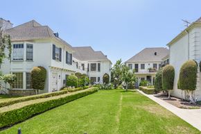 Los Angeles apartment for rent - a row of white houses with a lawn and a garden