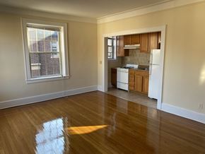 Summit apartment for rent - an empty living room and kitchen with wood floors