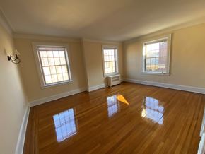 Summit apartment for rent - an empty living room with wooden floors and two windows