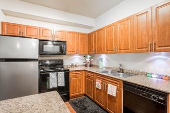 Fully equipped kitchen includes frost-free refrigerator, electric range, & dishwasher