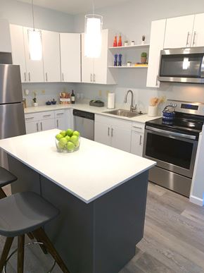 Merrimack apartment for rent - a kitchen with white cabinets and stainless steel appliances and a white counter top