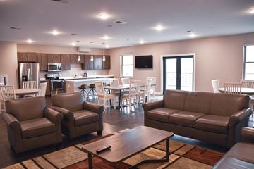 Richland Center apartment for rent - a living room with couches and chairs and a kitchen with a table