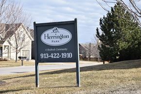 Shawnee apartment for rent - A sign for Herrington Park, a Rodrock community, is displayed in front of a house.