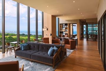 Chicago apartment for rent - A living room with a large couch and a view of the ocean.