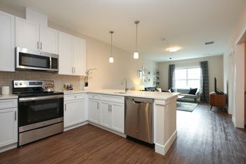 Designer kitchens featuring stainless steel appliances, calacatta quartz counter-tops, tile back-splash, and over-sized cabinets