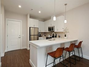 Elmsford apartment for rent - an open kitchen with a large island with three chairs