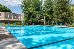 Rocky Hill apartment for rent - a resort style pool with blue chairs around it