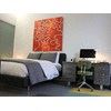 Cleveland apartment for rent - A bedroom with a bed, nightstand and chair.